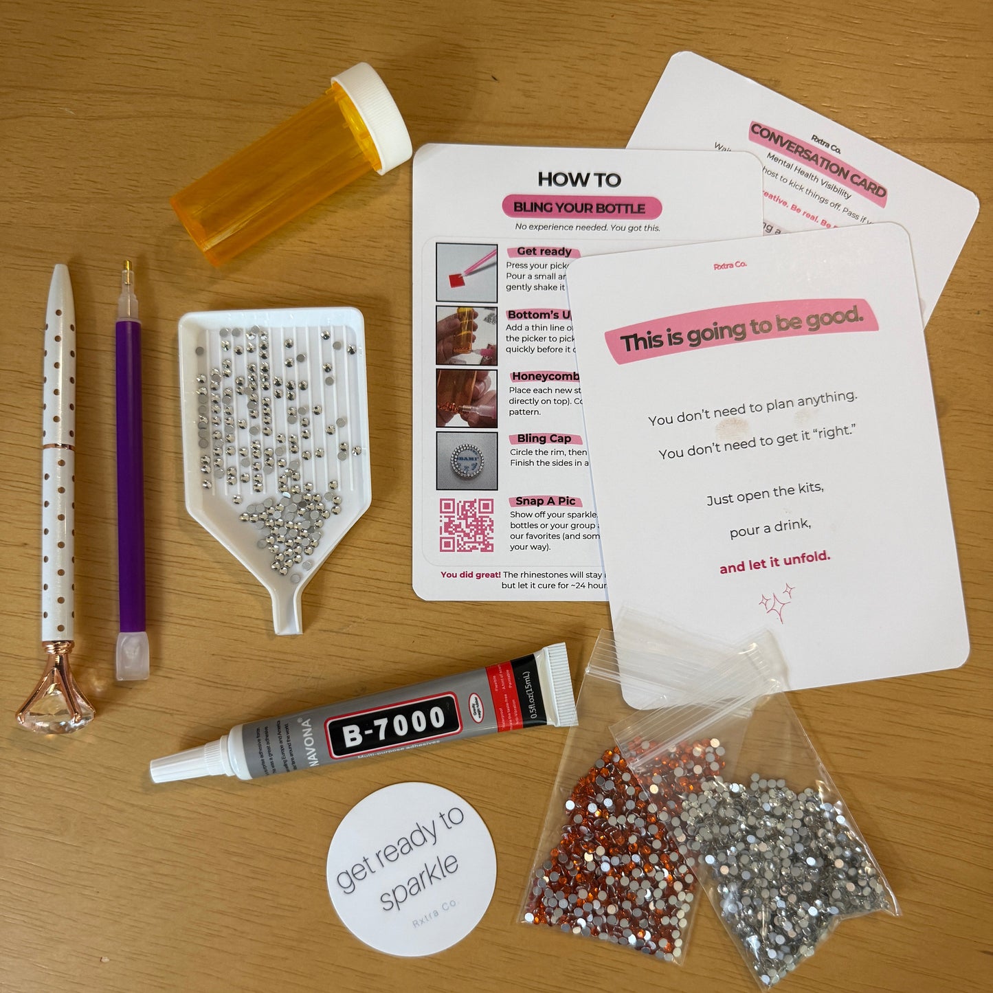 Assorted items including a pill bottle, pen, and small containers on a wooden surface.
